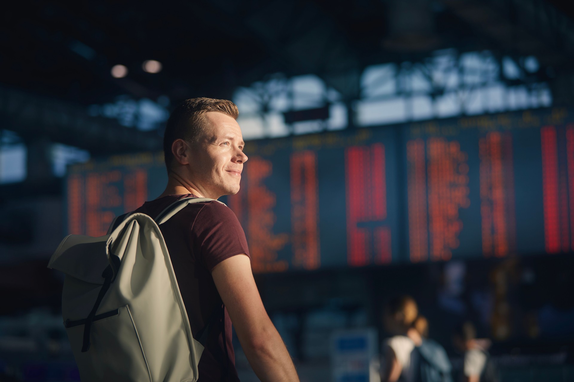 Portrait of man walking through airport terminal